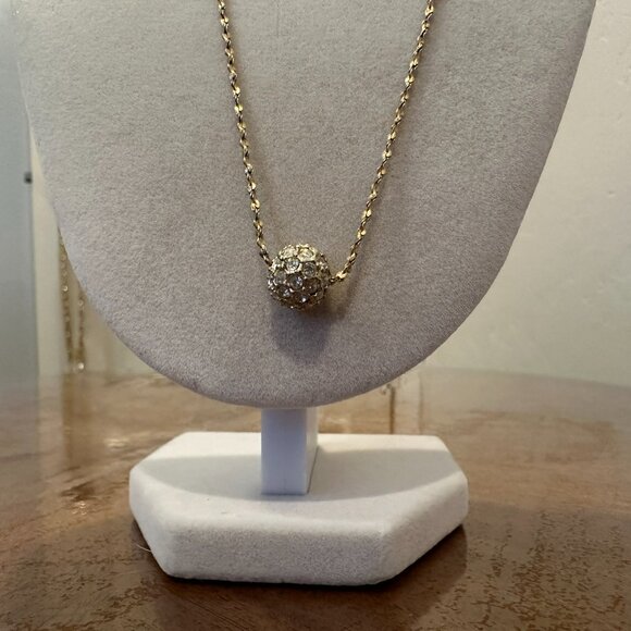 This necklace is a gold-tone with a rhinestone ball pendant. - Picture 3 of 7